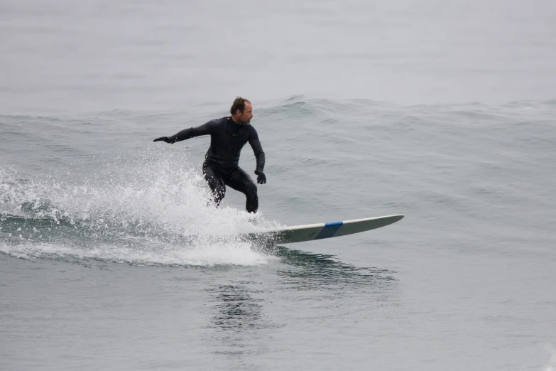 the man rides the surfboard in the water