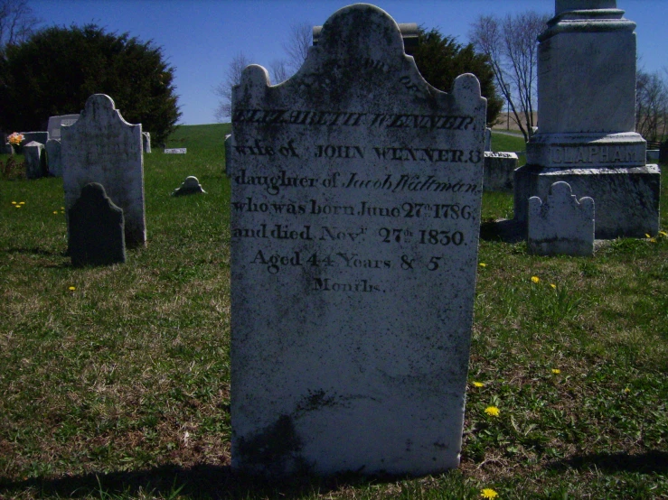 a large monument with writing on it is in a field