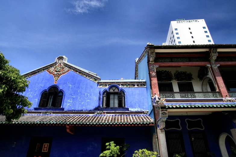 two buildings side by side, one with a clock on top