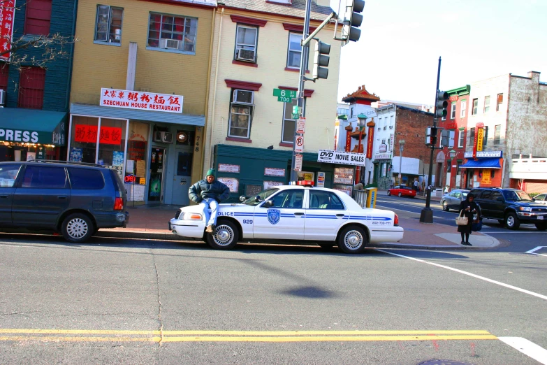 there is a police car driving down this street