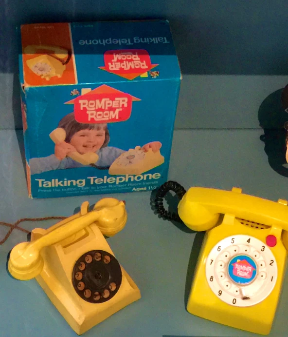 a box, telephone and small toy in a corner