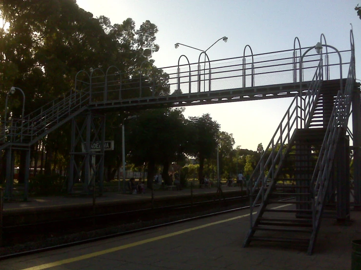 a metal stairway is near a rail track