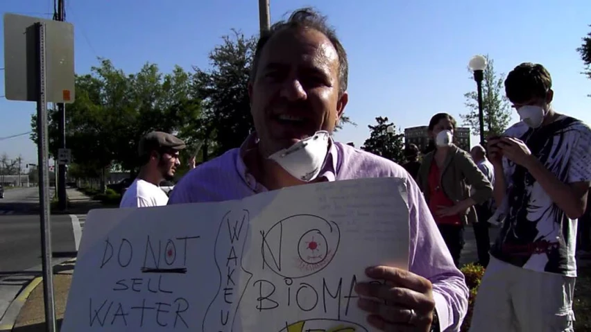 some guys holding up signs protesting water