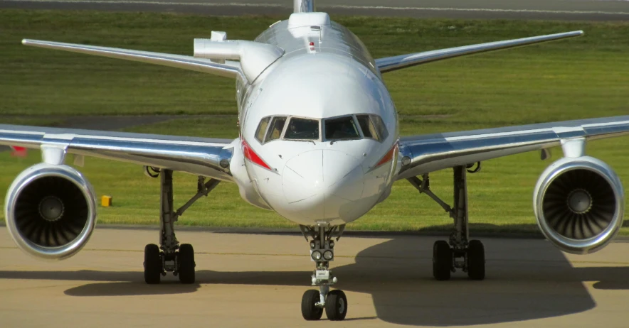 an airplane is parked on a runway by itself