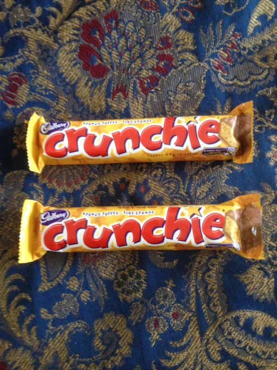 two peanut er crunchie bars sitting on top of a carpet