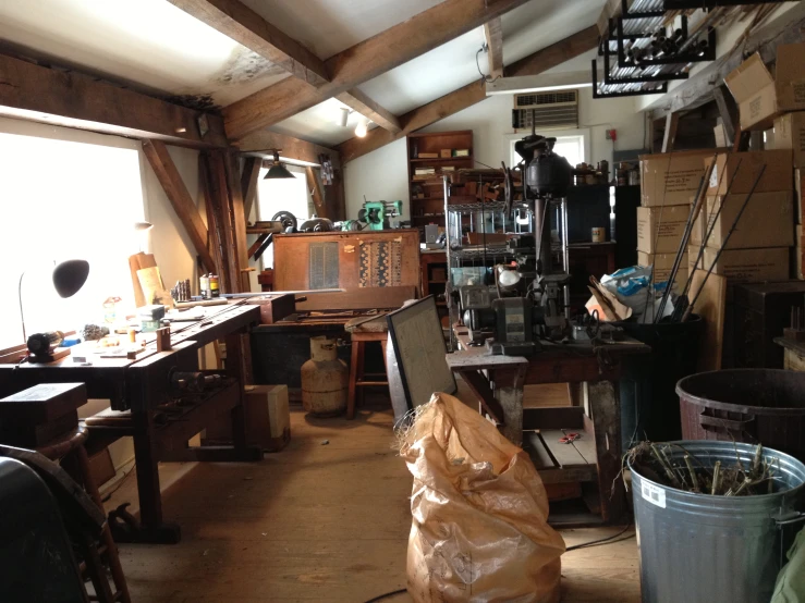 a wood burning stove sitting in a room filled with wooden boxes