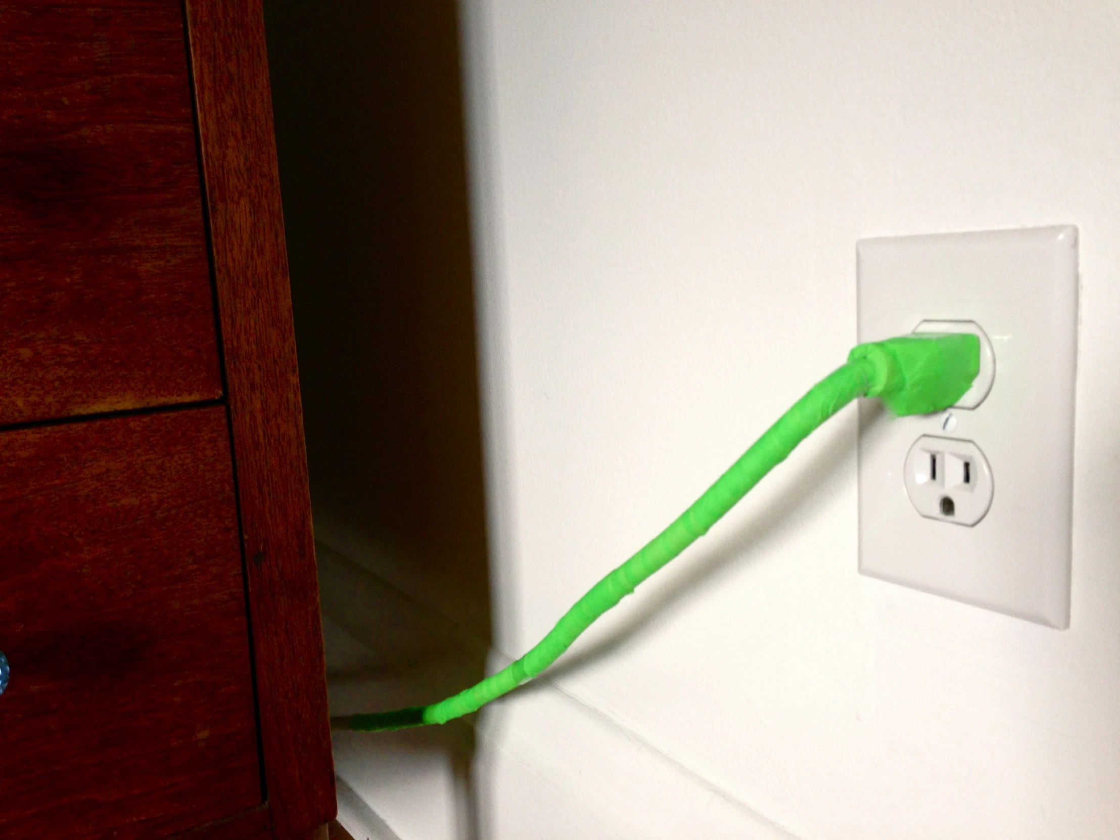 a cord connected to the side of an electric outlet