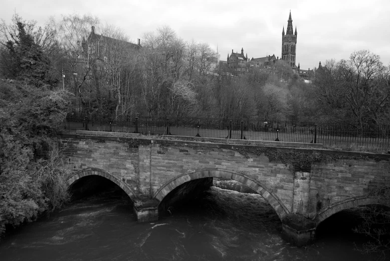black and white image of a bridge over water
