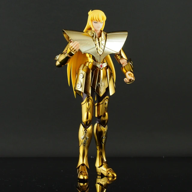a robot toy with gold armor is posed for a picture