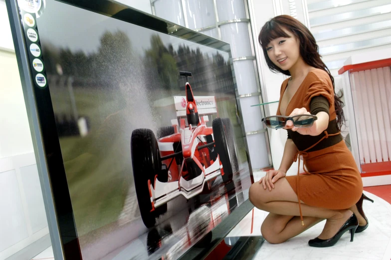 woman in short skirt holding remotes looking at large television screen