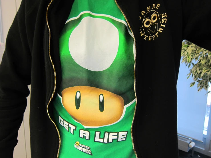 a guy wearing a shirt with a super mario bros ad on it