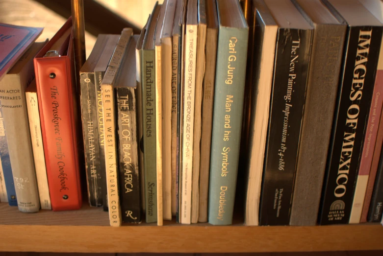 books are stacked up on a book shelf