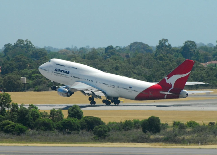 a large passenger jet flying over a tarmac