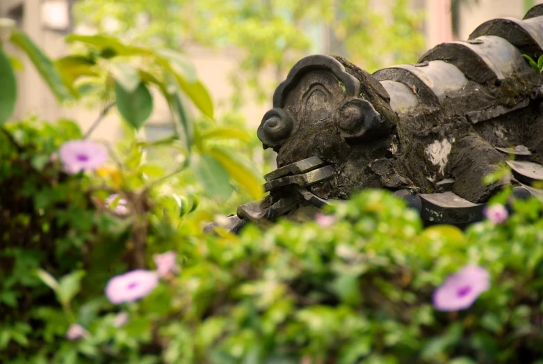 a garden sculpture that is covered in dirt