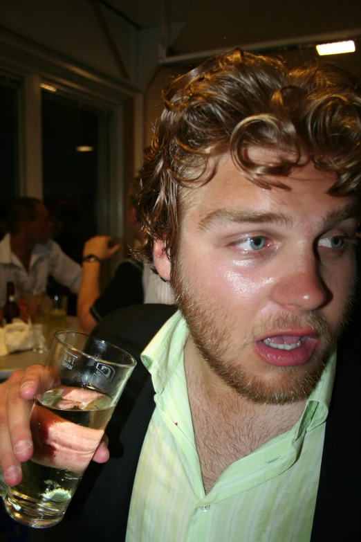 a man holding a wine glass up to the camera