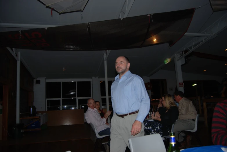 a man is standing in a bar with friends