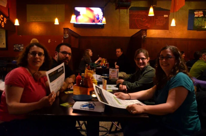 a group of people at a table with menus