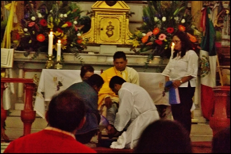 a group of people kneel down and pray