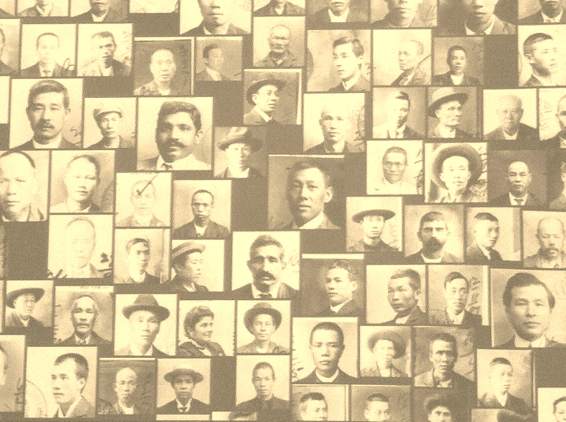 a wall covered with many different men's heads