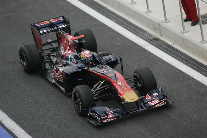 a red bull racing car speeding down the street