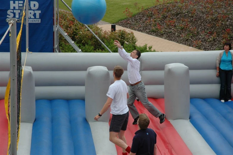 people standing on top of a giant inflatable ball