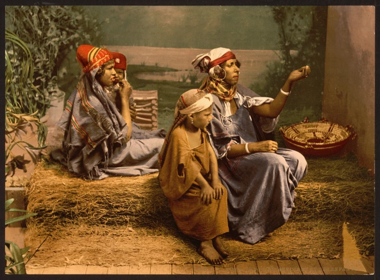 two indian women sitting and one on the floor