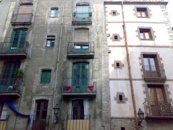 an apartment building with balconies and plants on the balcony