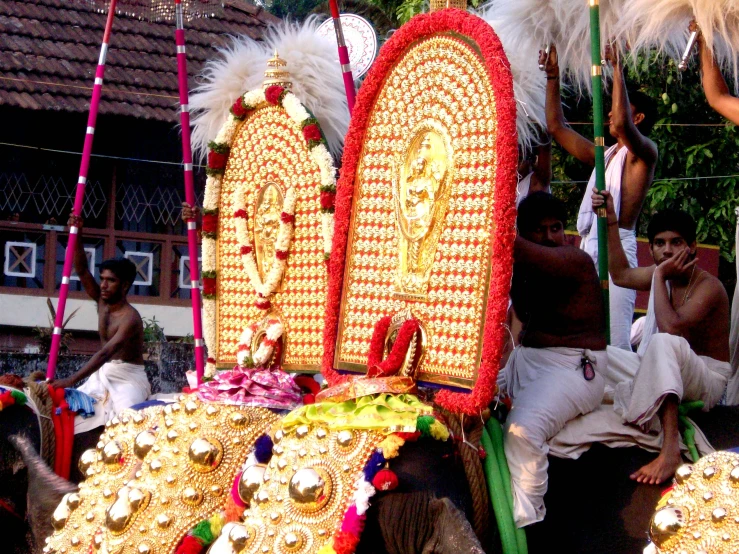 an elephant decorated with white feathers and decorations