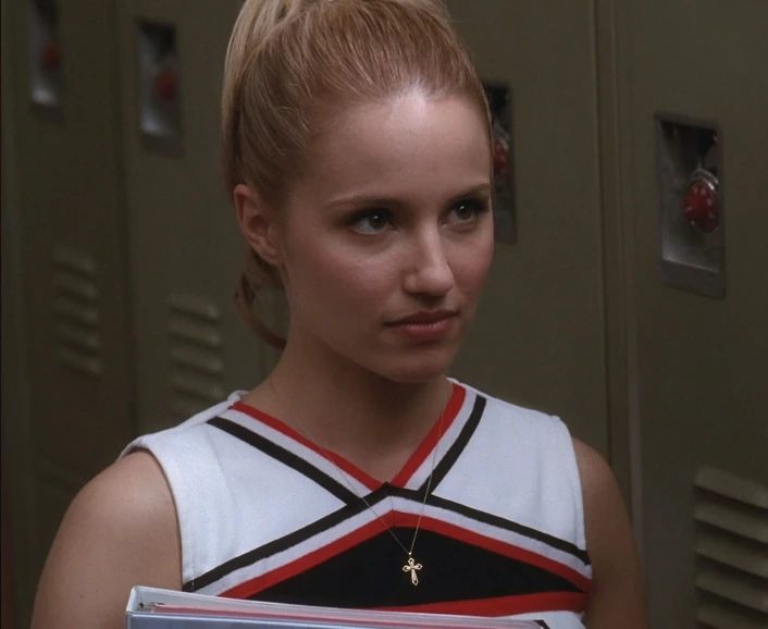 a woman with blonde hair and a uniform holds a box