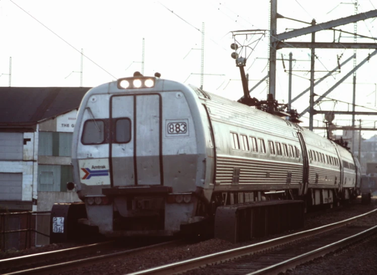 a train traveling down train tracks next to some buildings