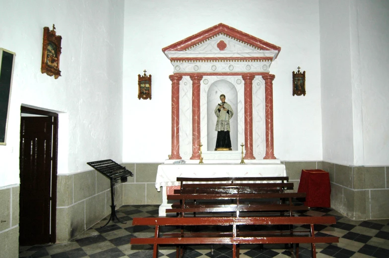 a red and white alter standing in a small room