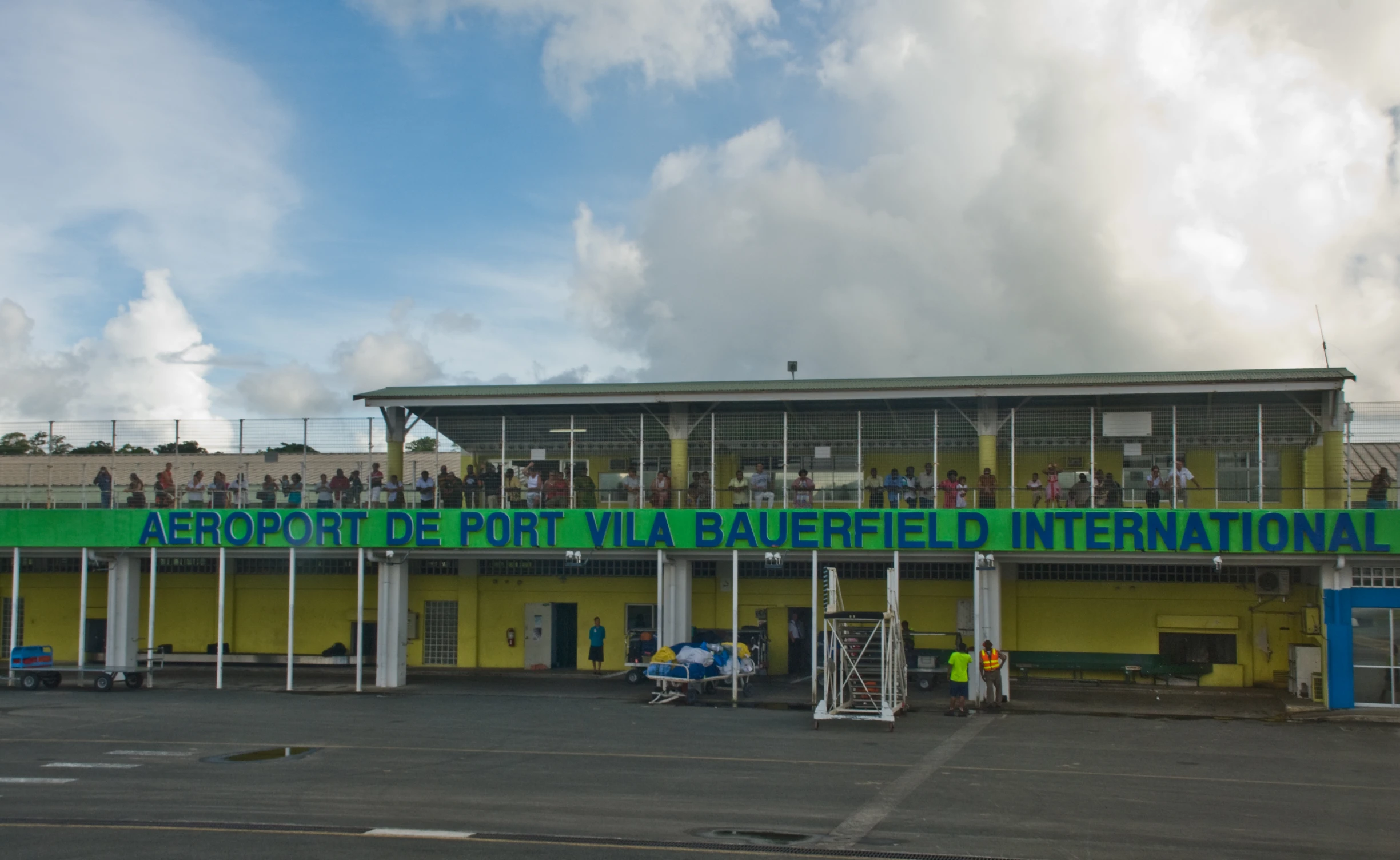 an exterior s of a el with people standing on the roof