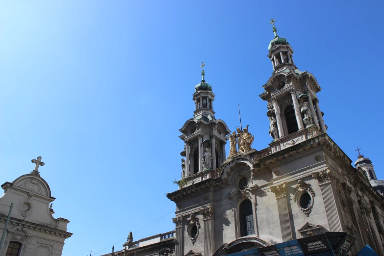 three tall spires stand atop a building in this old city