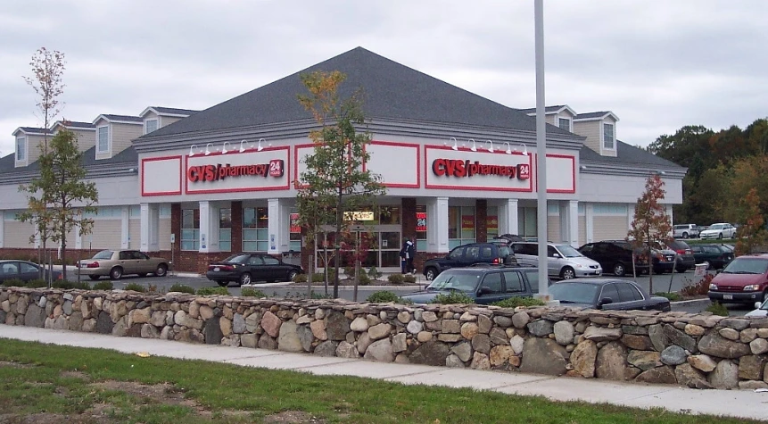 a view of a large retail store that has cars parked in front of it