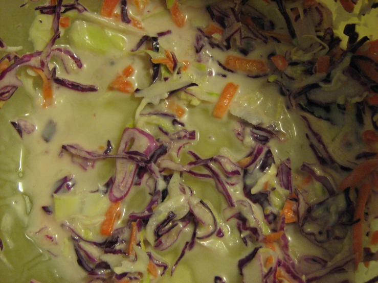 cabbage is covered with carrots and onions