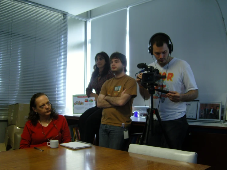 a couple of men and woman with headphones