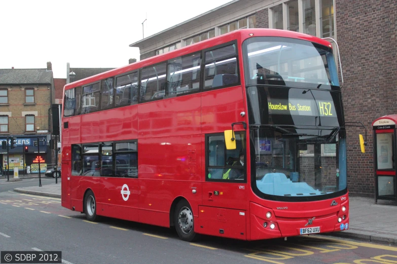 a red double decker bus on the road