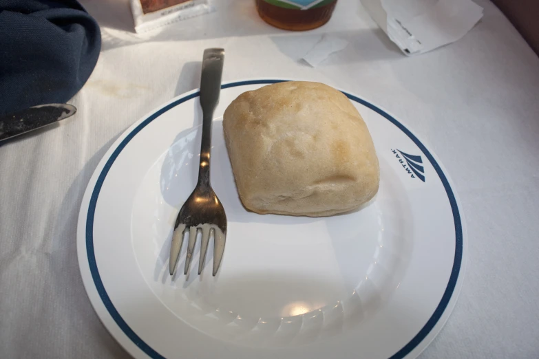 a meal on a plate on a table next to a knife and fork