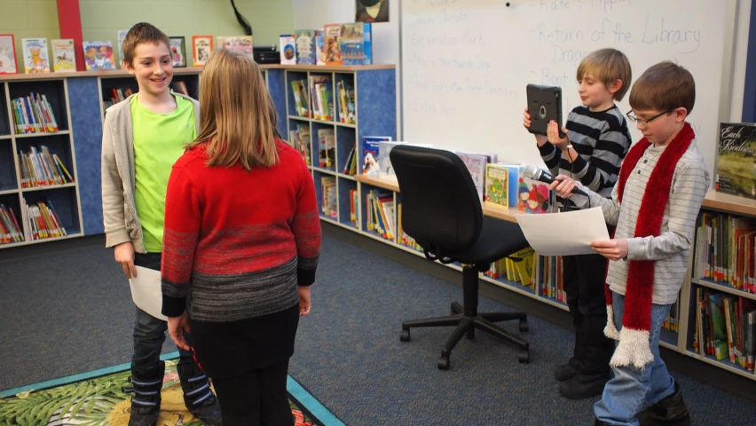 a group of s are looking at some books