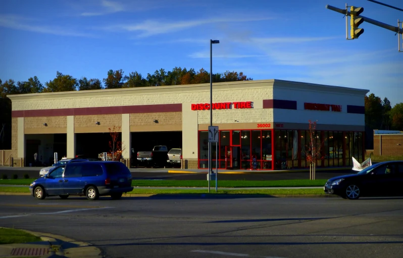 two vehicles parked outside the building where the store is located