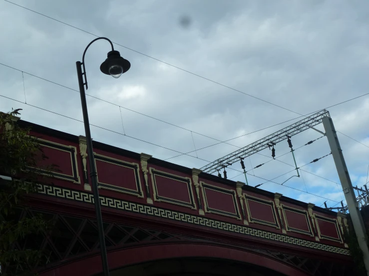 the light is above the train tracks under the clouds