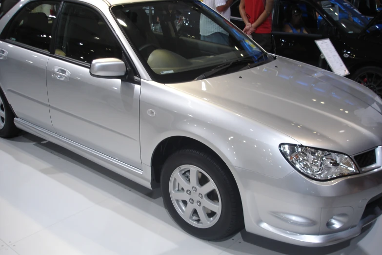 the white car is sitting on display at the show