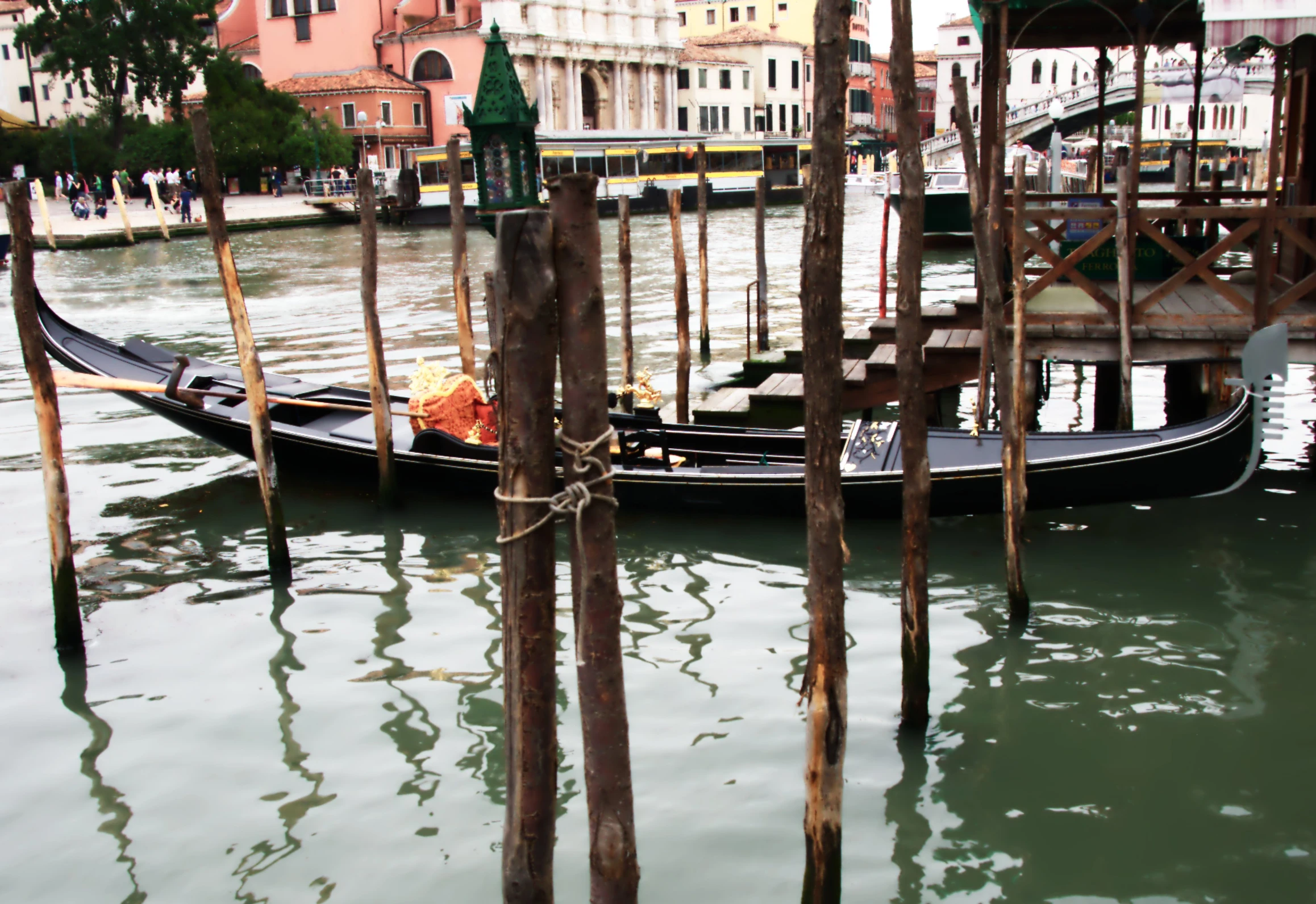a gondola is tied to two poles in a venice canal