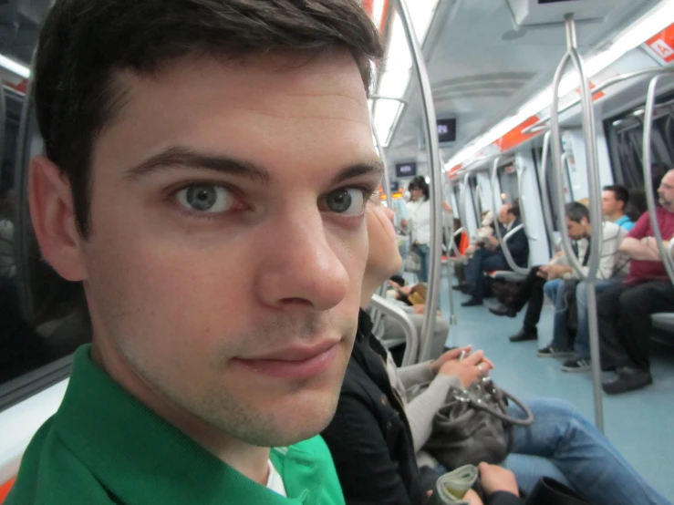 a man in a green tie is on the subway