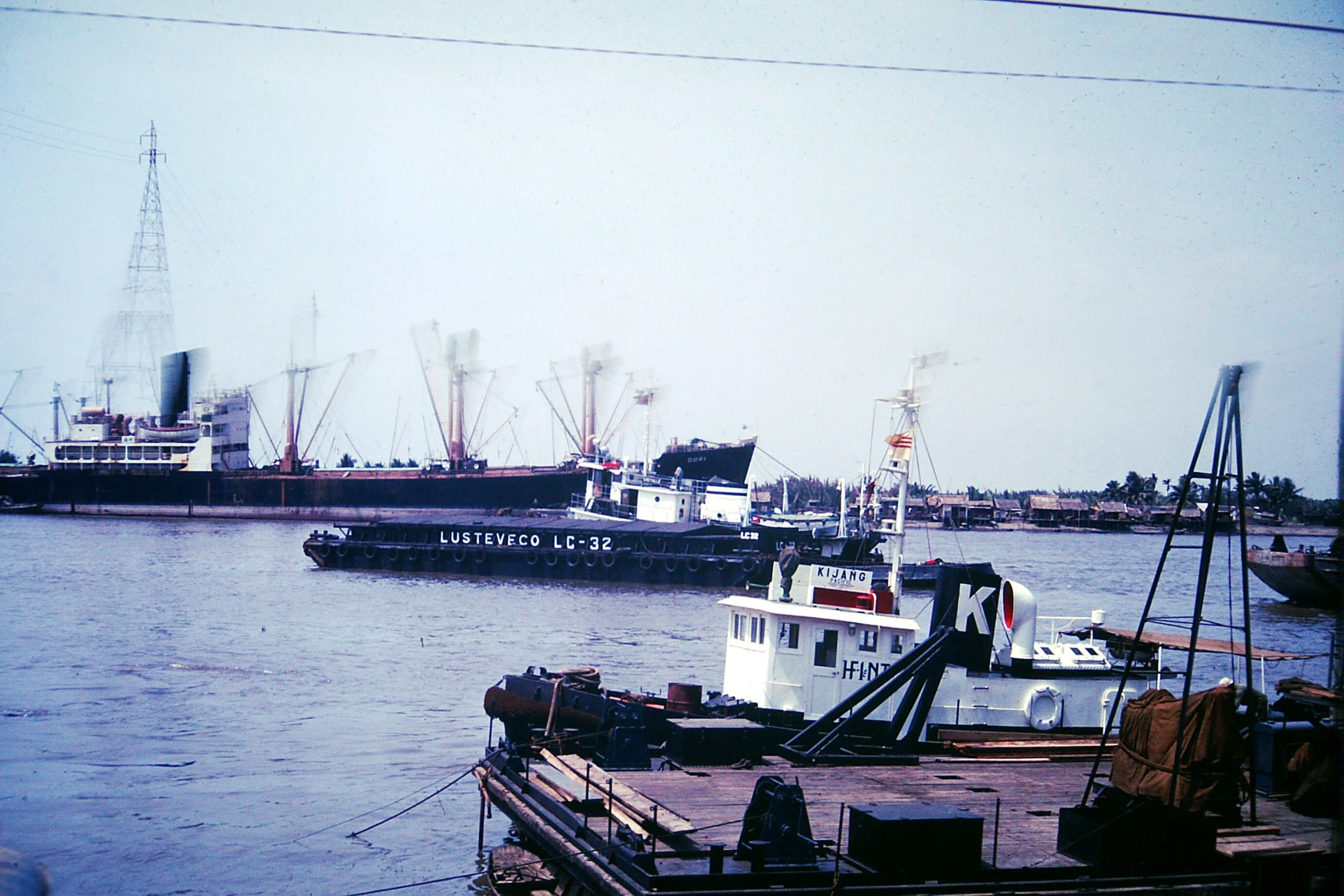 a large ship in the water is docked next to a tugboat