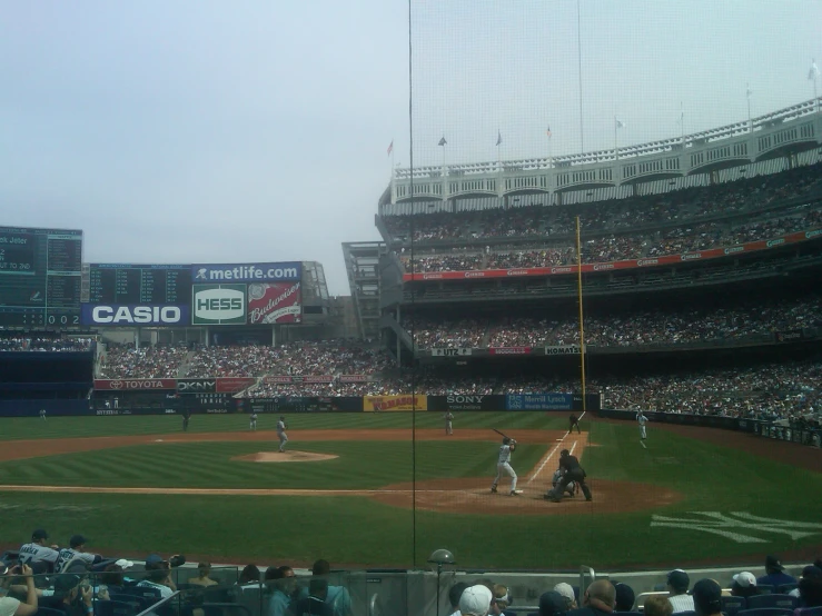 a group of people that are playing baseball in a field