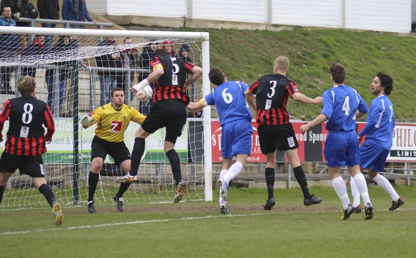 a soccer player jumping into the air to block a ball