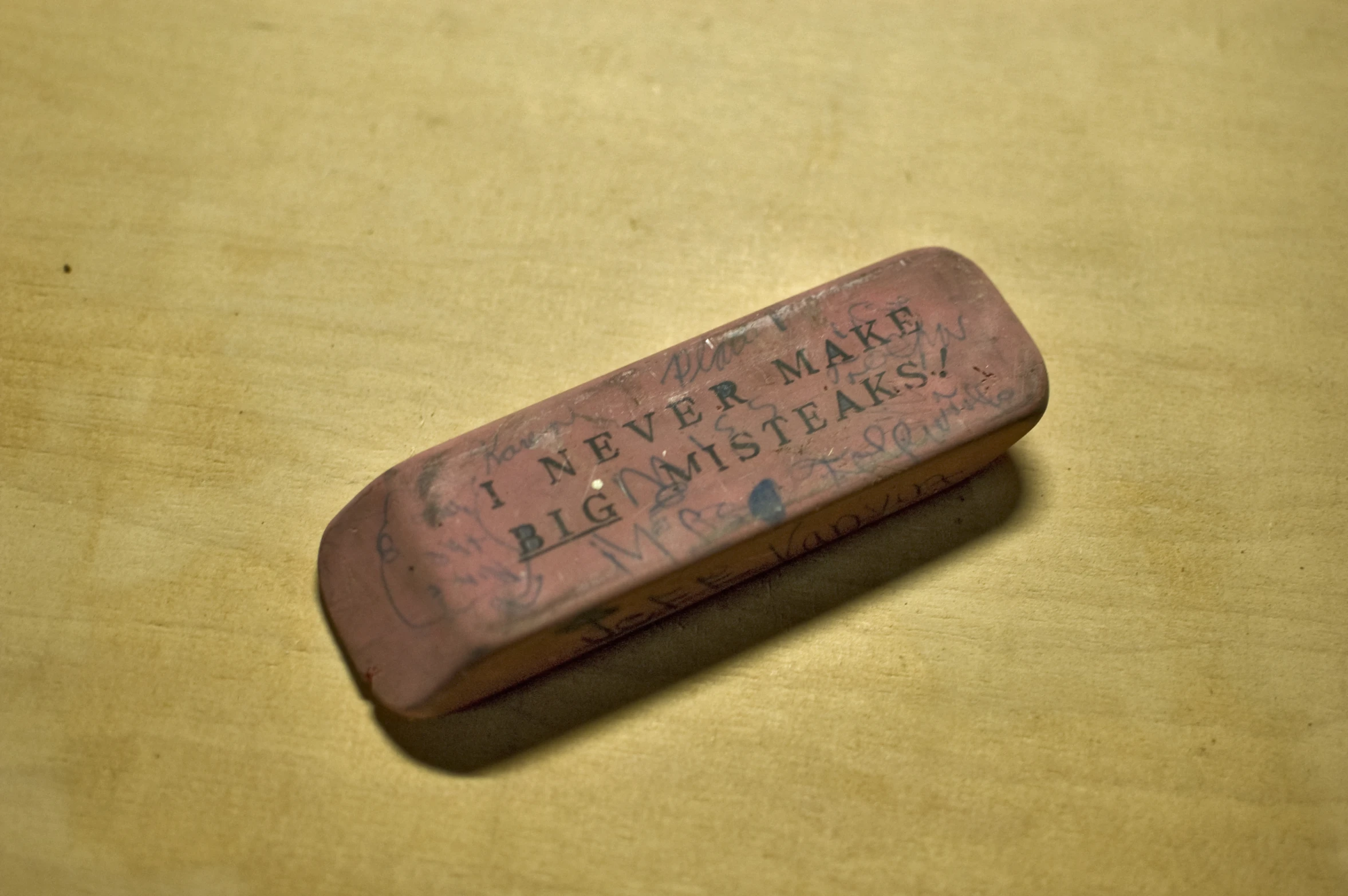 a wooden box with a brown lid and writing on it