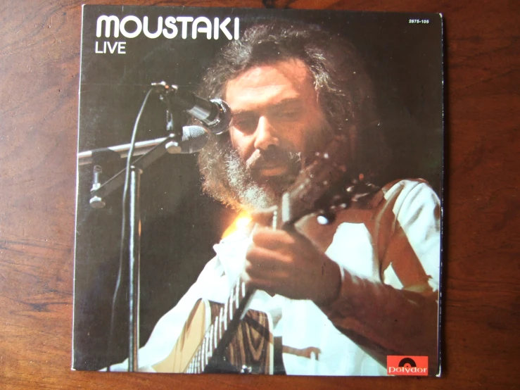 the cd cover for moustak is on display