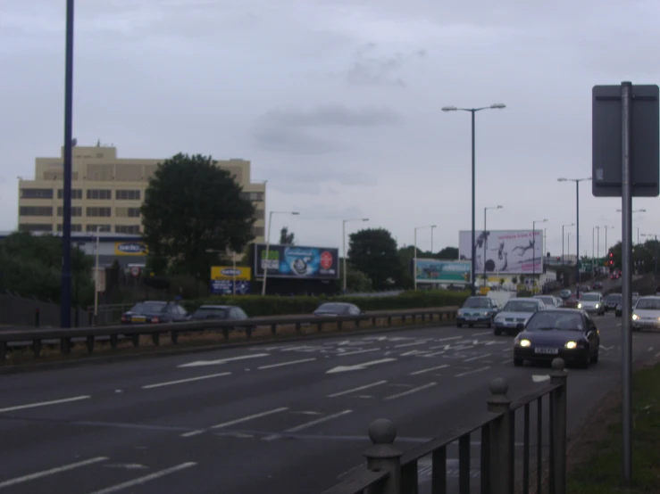 cars traveling down a road surrounded by traffic lights